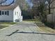 Spacious gravel driveway leading to a delightful home with mature trees at 512 Texas Ave, Burlington, NC 27217