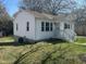 Quaint home featuring classic siding, a welcoming porch, and a well-kept lawn at 512 Texas Ave, Burlington, NC 27217