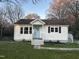 Charming home showcasing a neatly maintained lawn, a quaint porch, and classic siding at 512 Texas Ave, Burlington, NC 27217