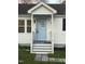 Inviting front entrance with a light-colored door, crisp white trim, and stone pathway at 512 Texas Ave, Burlington, NC 27217