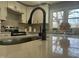 Close up of kitchen island with black sink fixture, quartz counter, and decorative lemons at 512 Texas Ave, Burlington, NC 27217