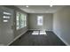 Living room featuring modern gray vinyl floors, neutral walls and ample natural light at 512 Texas Ave, Burlington, NC 27217