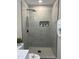 This bathroom features a stand up shower with beautiful gray tiling and modern fixtures at 512 Texas Ave, Burlington, NC 27217