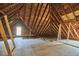 Unfinished attic featuring exposed wood beams and structure, offering ample space for potential expansion at 523 N Main St, Graham, NC 27253