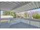Back porch with white railing, view of backyard with blooming trees, creating an inviting and scenic outdoor space at 523 N Main St, Graham, NC 27253