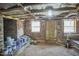 Basement showing brick foundation and wooden door with windows, indicating a functional and secure space at 523 N Main St, Graham, NC 27253