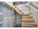 Basement stairs leading to an unfinished space, highlighting the potential for customization and storage at 523 N Main St, Graham, NC 27253