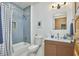 Stylish bathroom featuring subway tile shower and a modern wood vanity with gold hardware at 523 N Main St, Graham, NC 27253