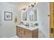Modern bathroom features a double vanity with stone countertop, gold fixtures, and decorative mirrors at 523 N Main St, Graham, NC 27253