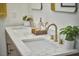 Bathroom with double sinks, marble countertop, and gold fixtures at 523 N Main St, Graham, NC 27253