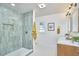 Bathroom featuring a glass shower, wood vanity with double sinks, and neutral decor at 523 N Main St, Graham, NC 27253