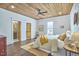 Bright bedroom with a wood-paneled ceiling, hardwood floors, and a comfortable bed with stylish bedding at 523 N Main St, Graham, NC 27253