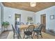 Charming dining room with wood ceiling, wooden table, and jute rug, perfect for gatherings at 523 N Main St, Graham, NC 27253