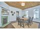 Inviting dining room featuring a green-tiled fireplace, wooden table, and wood ceiling at 523 N Main St, Graham, NC 27253