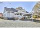 Exterior of a two-story home showcasing a white exterior, backyard, and ample parking at 523 N Main St, Graham, NC 27253
