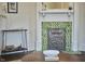 Elegant fireplace with decorative tiles, providing a charming focal point in the living room at 523 N Main St, Graham, NC 27253