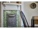 Close-up of a charming fireplace with green tile and decorative deer grate at 523 N Main St, Graham, NC 27253