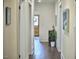 Inviting hallway with hardwood floors and neutral walls, leading to a bright entryway at 523 N Main St, Graham, NC 27253