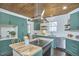 Modern kitchen featuring a wood ceiling, stainless steel appliances, and custom green cabinets, perfect for cooking at 523 N Main St, Graham, NC 27253
