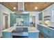 Spacious kitchen with a wood plank ceiling, green cabinets, and stainless hood at 523 N Main St, Graham, NC 27253