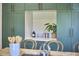 Kitchen bar area with green cabinets and a view into an adjacent area at 523 N Main St, Graham, NC 27253