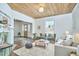 Cozy living room with hardwood floors, a wood-paneled ceiling, and stylish furniture, creating a warm atmosphere at 523 N Main St, Graham, NC 27253