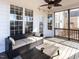 Covered back porch with ceiling fan, wood floor, and plush outdoor seating at 543 Chatham Forest Dr, Pittsboro, NC 27312