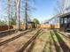 Spacious backyard with grass, dirt, mature trees, and exterior view of home at 543 Chatham Forest Dr, Pittsboro, NC 27312