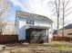 Backyard view of home's exterior and covered back porch surrounded by a wood fence at 543 Chatham Forest Dr, Pittsboro, NC 27312