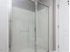 Modern bathroom boasting a glass-enclosed shower with white tile and a door leading to the outside at 543 Chatham Forest Dr, Pittsboro, NC 27312