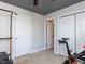 Bedroom with gray walls, exercise equipment and view of closet and attached bathroom at 543 Chatham Forest Dr, Pittsboro, NC 27312