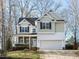Charming two-story home with a manicured lawn, a two-car garage and inviting front porch at 543 Chatham Forest Dr, Pittsboro, NC 27312