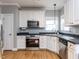 Kitchen with stainless steel oven, microwave, dishwasher, and light colored cabinets at 543 Chatham Forest Dr, Pittsboro, NC 27312
