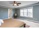Bright and airy main bedroom featuring large windows, carpet, and a serene atmosphere at 543 Chatham Forest Dr, Pittsboro, NC 27312
