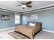 Comfortable main bedroom with large windows and carpet flooring, decorated with modern decor at 543 Chatham Forest Dr, Pittsboro, NC 27312