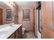 Bathroom with double sinks, wood cabinets, tile floor, toilet and shower at 5437 Grasshopper Rd, Raleigh, NC 27610