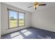 Bedroom with a window view of a landscape, a ceiling fan, and patterned carpeting at 5437 Grasshopper Rd, Raleigh, NC 27610