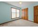 Comfortable bedroom featuring a window with blinds and a closet for storage at 5437 Grasshopper Rd, Raleigh, NC 27610