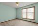 A bright bedroom offers a window with blinds and neutral carpet at 5437 Grasshopper Rd, Raleigh, NC 27610