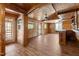 Spacious room with wood flooring, paneled walls, ceiling fan and serving bar at 5437 Grasshopper Rd, Raleigh, NC 27610