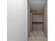 A closet space with shelves and a clothing rod is lit by a ceiling light at 5437 Grasshopper Rd, Raleigh, NC 27610
