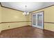 Dining room with chandelier and white french doors at 5437 Grasshopper Rd, Raleigh, NC 27610