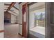 Inviting doorway with a view of a spacious living room with fireplace and access to an outdoor porch at 5437 Grasshopper Rd, Raleigh, NC 27610