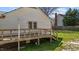 View of a home with a deck, enhanced by a well-maintained yard with lush green grass at 5437 Grasshopper Rd, Raleigh, NC 27610