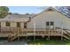 Home featuring a spacious deck with convenient access stairs, perfect for enjoying outdoor living at 5437 Grasshopper Rd, Raleigh, NC 27610