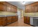 Eat-in kitchen features wood cabinets, linoleum flooring, and open access to another room at 5437 Grasshopper Rd, Raleigh, NC 27610
