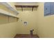 Laundry room with wood flooring, shelves and yellow painted walls at 5437 Grasshopper Rd, Raleigh, NC 27610