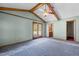 Living room with blue walls, wood beam ceiling, fan, and double doors leading to a deck at 5437 Grasshopper Rd, Raleigh, NC 27610