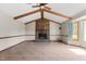 Living room with vaulted ceiling, wooden beams, brick fireplace, tile floor, and window at 5437 Grasshopper Rd, Raleigh, NC 27610