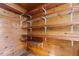 Walk-in pantry with wood flooring and wood shelves, providing ample storage space at 5437 Grasshopper Rd, Raleigh, NC 27610